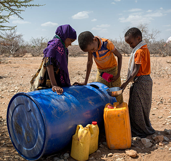 Aufgrund der Dürre müssen viele Menschen in Somalia mit einem Kanister zur nächstgelegenen Straße gehen und auf vorbeifahrende Wasserwagen warten, um sauberes Trinkwasser zu erhalten.