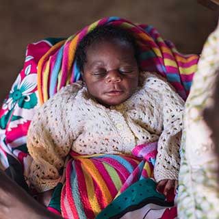 Titelbild des Jahresberichts 2021 von Save the Children Deutschland. Ein Neugeborenes in Kenia. © Sarah Waiswa / Save the Children