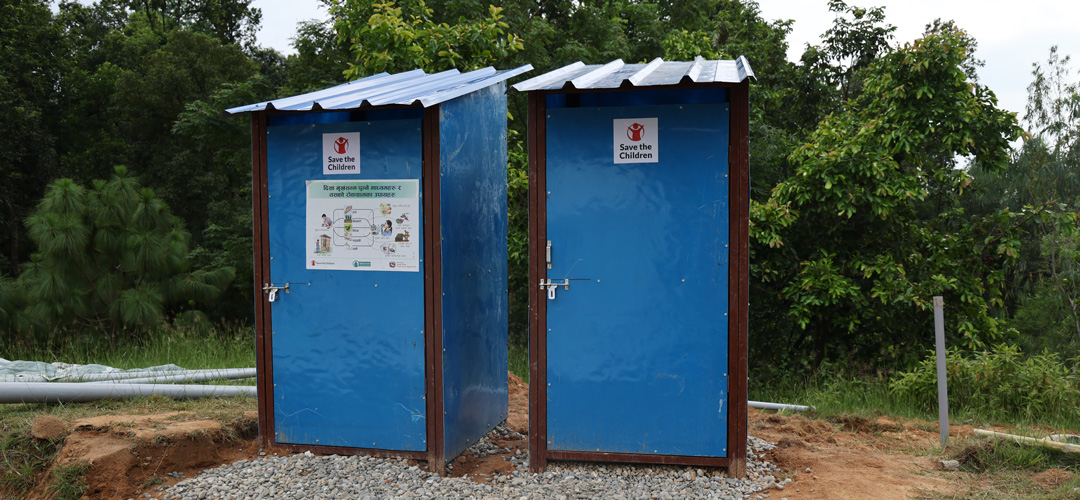 Nowakot: Unsere Teams stellen Toiletten sowie Waschbecken (nicht im Bild) auf. © Sirish Burlakoti / Save the Children Zwei einfache, abschließbare Latrinen stehen in der Landschaft.