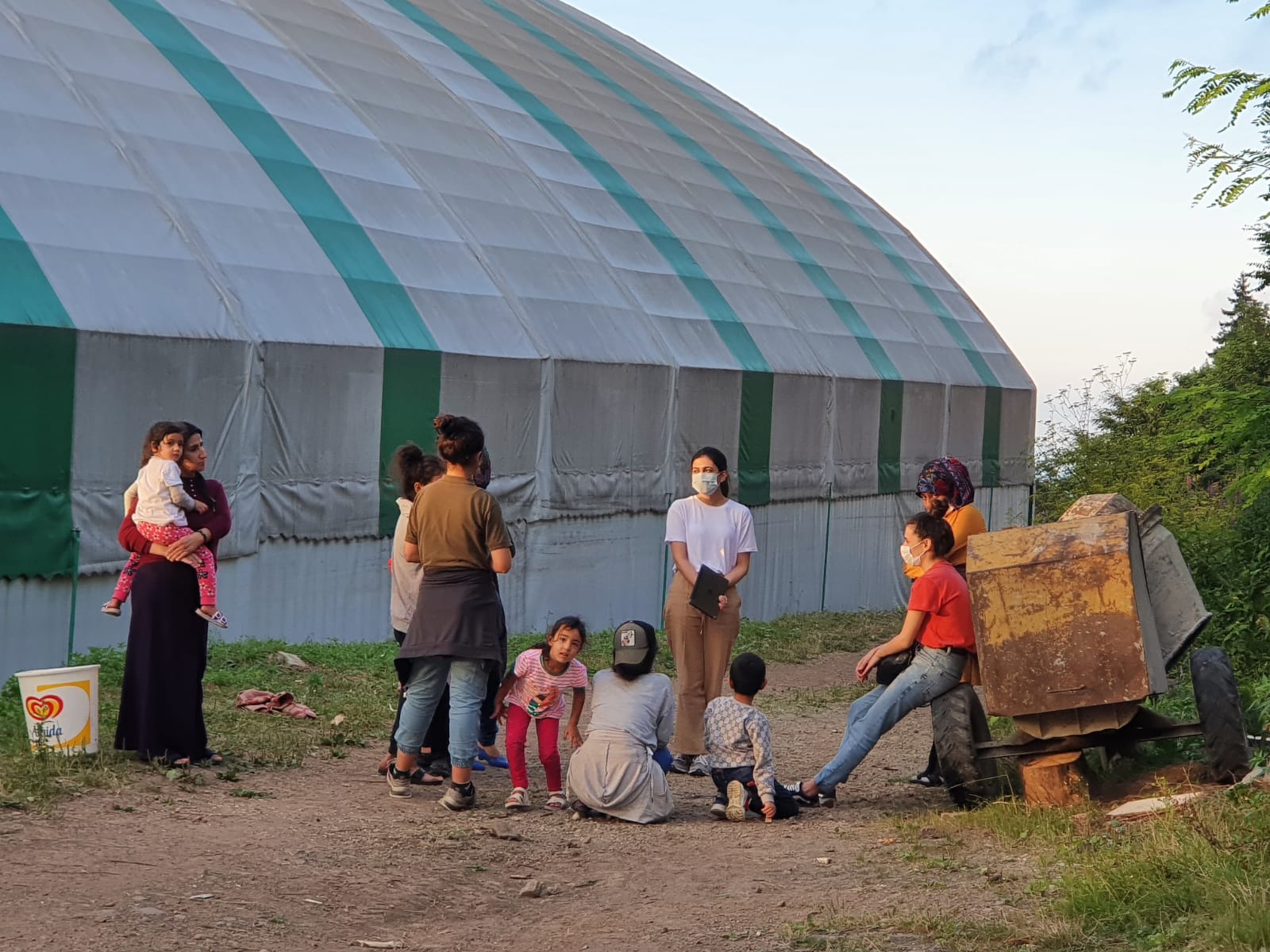 THE CENTRE im Gespräch mit Kindern und Familien  vor ihren temporären Unterkünften während der Erntezeit.